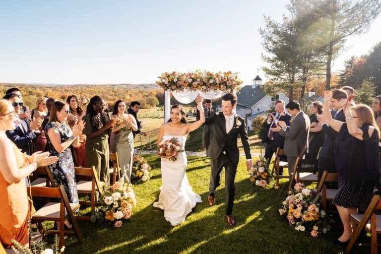 Scenic outdoor wedding ceremony at Milea Estate Vineyard with rolling hills and vineyards in the background